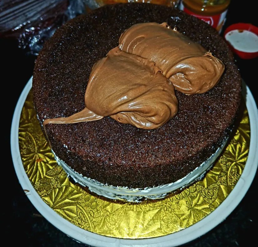 Chocolate sponge cake with biscotti-style filling being added